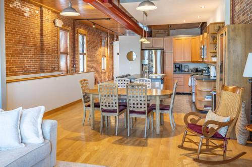 a kitchen and dining room with a table and chairs at Gorgeous apartment across from La Crosse Center in La Crosse