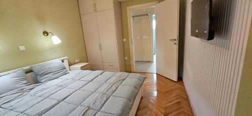 a bedroom with a bed and a door to a hallway at ATLANTIC Apartments in Štip