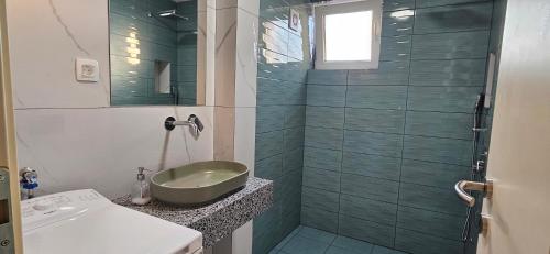 a bathroom with a sink and a shower at ATLANTIC Apartments in Štip