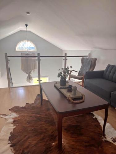 a living room with a coffee table and a couch at Cosy country house near city in Jönköping