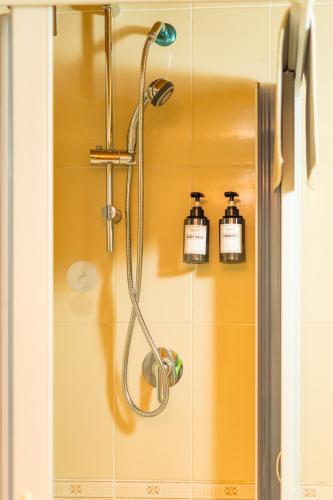 a shower with a shower head in a bathroom at E-Home in Volla