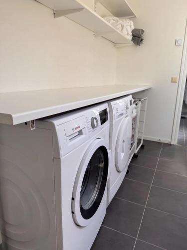 a white washer and dryer in a kitchen at Cosy country house near city in Jönköping