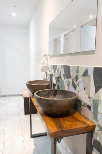 a bathroom with two sinks on a counter with a mirror at Modular Dreams in Madrid