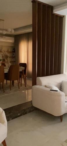 a living room with a white couch and a table at Luxury Duplex in Cairo