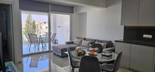 a living room with a couch and a table at AURA Apt Modern 1BR in Central Limassol and Free Parking in Limassol