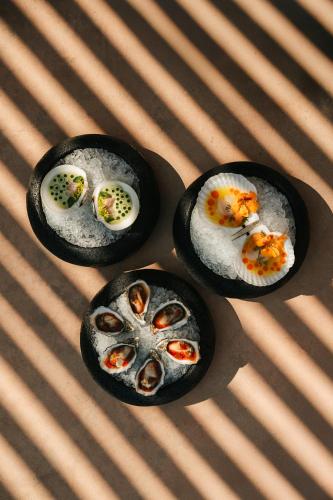 three bowls of food sitting on top of a table at MIRA Earth Studios in Valle de Guadalupe