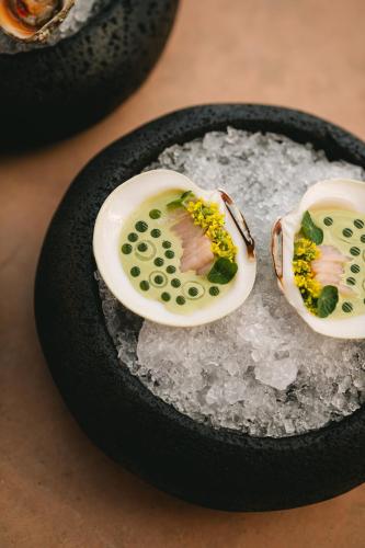 two deviled eggs on ice in a black bowl at MIRA Earth Studios in Valle de Guadalupe
