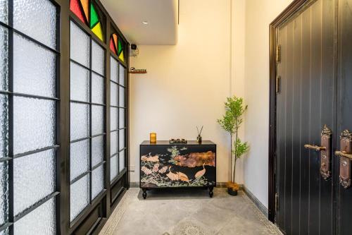 a room with a door and a table with a painting at A detached, old Shanghai villa on Huaihai Middle Road in Shanghai