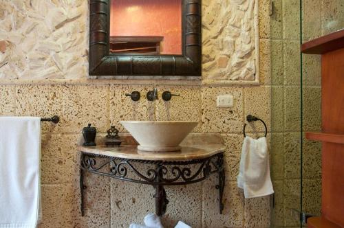 a bathroom with a sink and a mirror at Colonial Luxury Oasis In Cartagena's Old City in Cartagena de Indias
