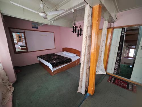 a bedroom with a bed and a whiteboard at Lake Boulevard Guest House in Srinagar