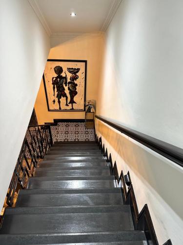 a staircase in a building with a painting on the wall at Maison Norelle at Isivuno House in Gillitts