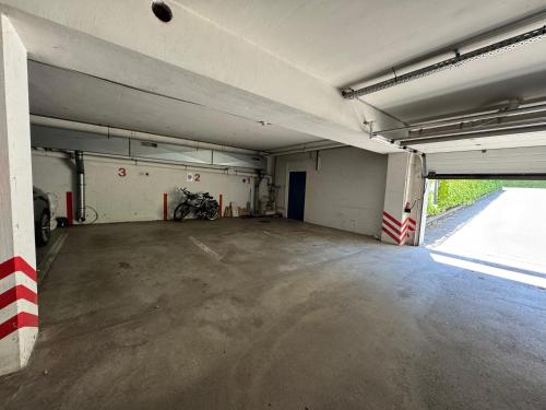 an empty parking garage with a motorcycle parked in it at Wilena Apartments in Villach