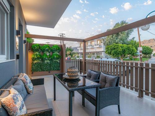 a patio with a table and chairs on a balcony at My Savvas Studios in Haraki