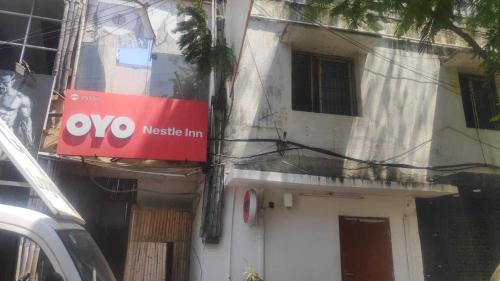 a building with a sign on the side of it at Hotel O Nestle inn in Chennai