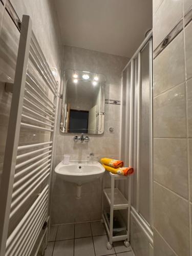 a small bathroom with a sink and a mirror at Penzion Ludor in Strážnice