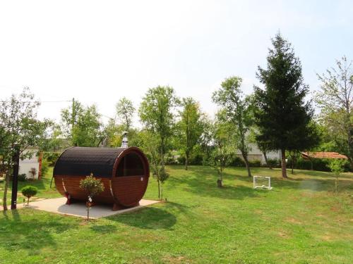a barrel in a grassy field with a park at Annie's apartment in Rakovica