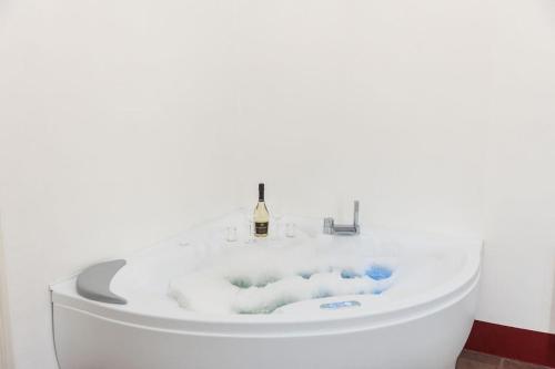 a bath tub with a bottle of wine in it at B&B MATINE' Suits & Rooms in Matino