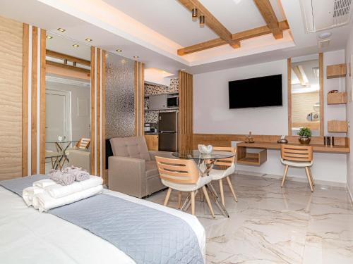 a bedroom with a bed and a living room at My Savvas Studios in Haraki