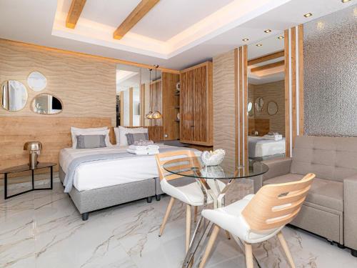 a bedroom with a bed and a glass table at My Savvas Studios in Haraki
