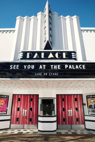 a theatre with red doors and a sign that reads palace see you at the palace at Modern 3BR, 2BAHome Near Georgetown Square Sleeps 6 in Georgetown