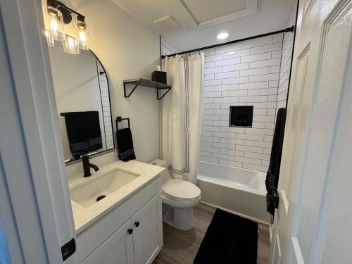 a white bathroom with a sink and a toilet at Modern 3BR, 2BAHome Near Georgetown Square Sleeps 6 in Georgetown