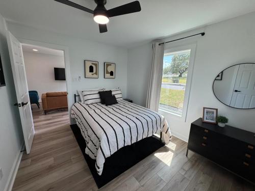 a bedroom with a bed and a large window at Modern 3BR, 2BAHome Near Georgetown Square Sleeps 6 in Georgetown