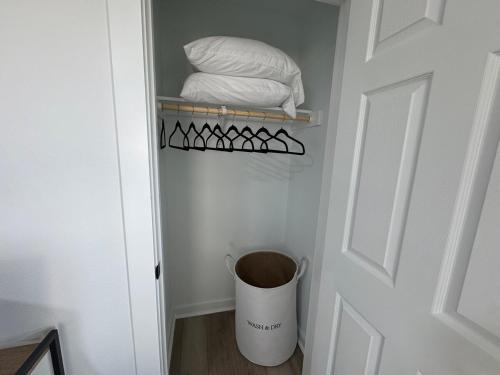 a hallway with a trash can next to a door at Modern 3BR, 2BAHome Near Georgetown Square Sleeps 6 in Georgetown