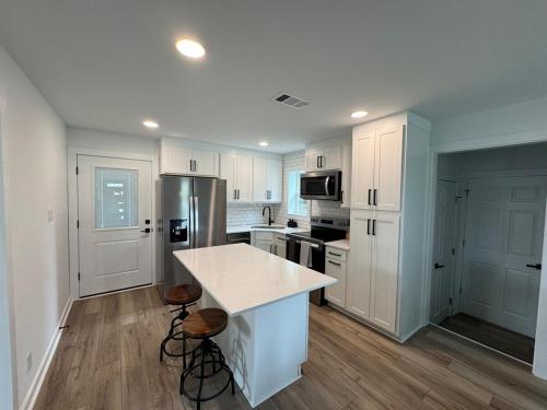 a kitchen with white cabinets and a white counter top at Modern 3BR, 2BAHome Near Georgetown Square Sleeps 6 in Georgetown