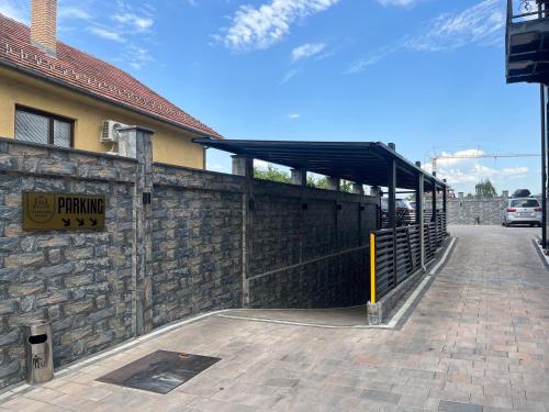 a building with a brick wall and a parking lot at Golden Hill Palace in Novi Pazar