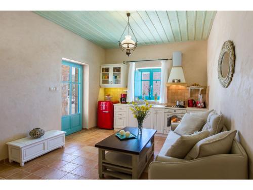 a living room with a couch and a table at Pandora in Pirgos Dhirou