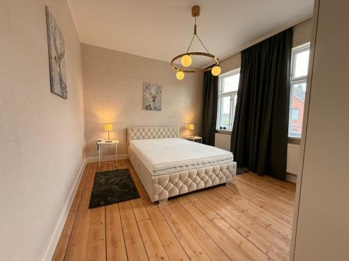 a bedroom with a white bed in a room at Renoviertes Haus am Sommerdeich in Freiburg - Elbe
