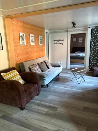 a living room with a couch and a bed at Gite de la Robella in Buttes