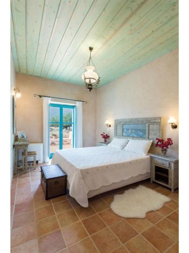 a bedroom with a large bed and a ceiling at Pandora in Pirgos Dhirou