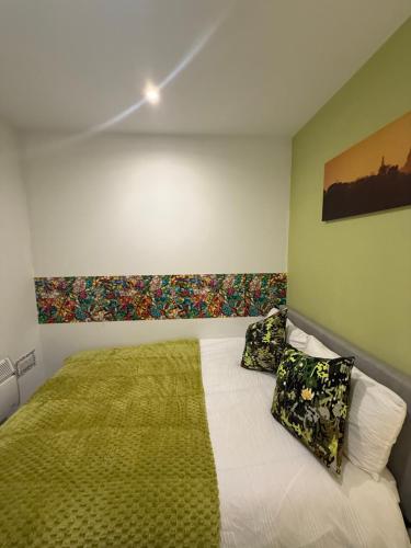 a bedroom with a bed with pillows on it at Oasis Urban retreat- Regent Street in Barnsley