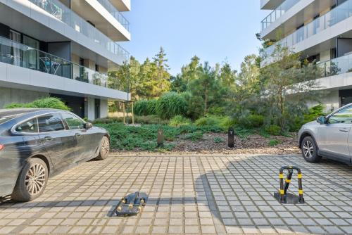 two parking meters in a parking lot in front of a building at Shelter Apartments by Solarento in Rogowo