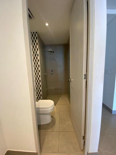 a bathroom with a toilet and a shower at Distrito 90 luxury suites in Barranquilla