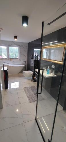 a large bathroom with a tub and a sink at Oaza nad Biebrzą in Goniadz