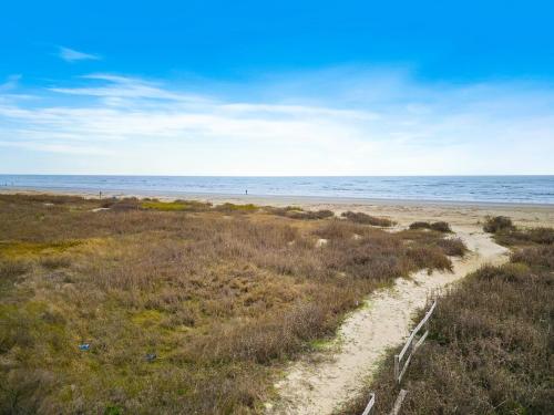 a sandy beach with the ocean in the background at Our Infinity Pool in Galveston