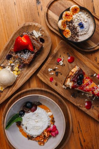 a group of plates of food on a wooden table at Surfescape Fuerteventura in Lajares