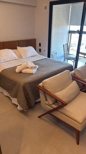 a bedroom with a bed with two towels on it at Flat 602 - Mn Concept in Marília