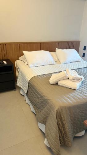 a bedroom with a bed with two towels on it at Flat 602 - Mn Concept in Marília