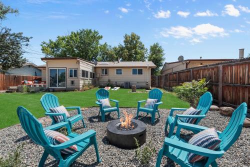 a group of chairs around a fire pit in a yard at Coffee Themed - Cozy Family Getaway - Sleeps 12 - Mini Golf BBQ Yard in Westminster