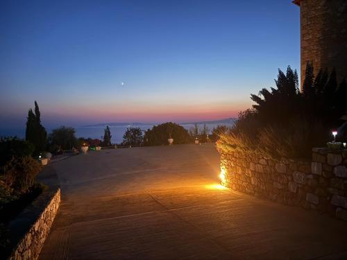 a stone wall with a sunset in the background at Angelikis Shared Home in Pírgos