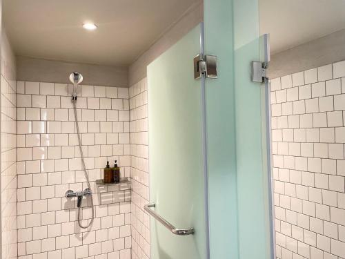 a shower with a glass door in a bathroom at GalileOasis Boutique Hotel in Bangkok