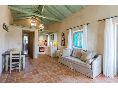 a living room with a couch and a table at Pandora in Pirgos Dhirou