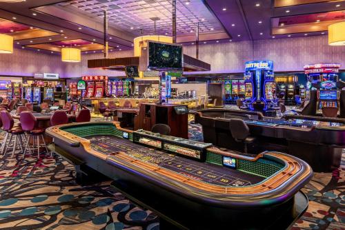 a casino with a bunch of machines and poker tables at Harrah's Metropolis, A Caesars Destination in Metropolis