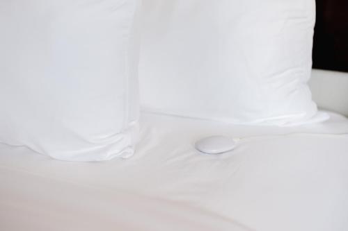 a white pillow with a spoon on a table at Comfort Inn & Suites Tobago in Tobago Island