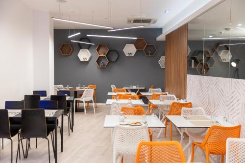 a dining room with tables and chairs at The ICONS Lisbon Hotel in Lisbon