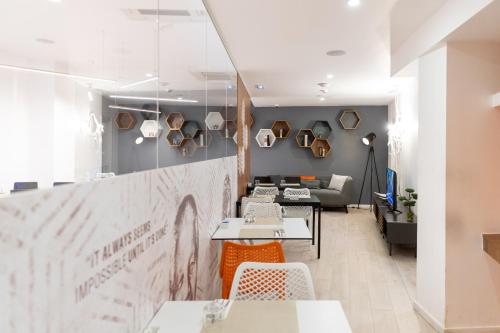 a restaurant with tables and chairs and a couch at The ICONS Lisbon Hotel in Lisbon
