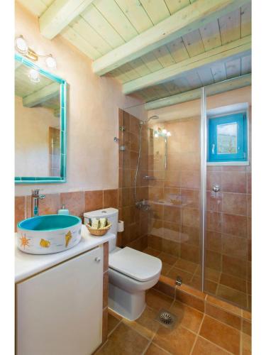 a bathroom with a toilet and a sink and a shower at Pandora in Pirgos Dhirou